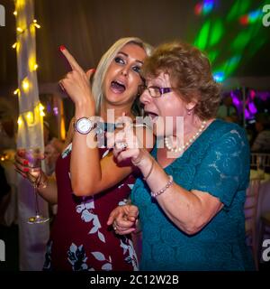Old and young having fun on the dance floor. British Wedding in South Cambridgeshire, England Stock Photo