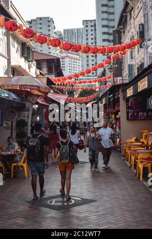 People walking on a street with decorative paper lanterns in Singapore China Town Stock Photo