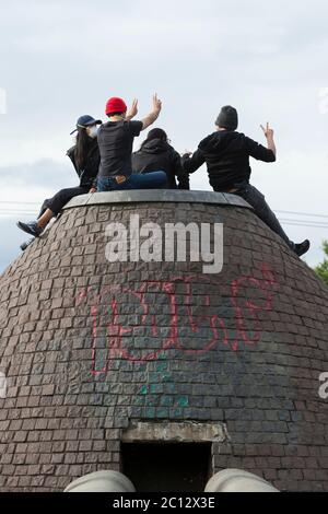 a group of friends pose for a photo on top of the fountain at cal anderson park in the capitol hill autonomous zone in seattle on friday june 12 2020 the zone also known as chaz is a self declared intentional community and commune established when the seattle police department closed the east precinct after days of large protests and occasional violent clashes