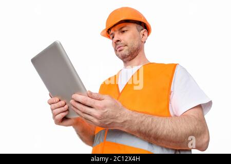 Serious Architect Using Digital Tablet Standing On White Studio Background Stock Photo
