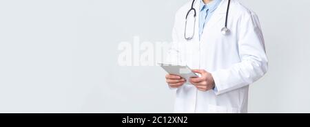 Professional doctor holding digital tablet in hands Stock Photo
