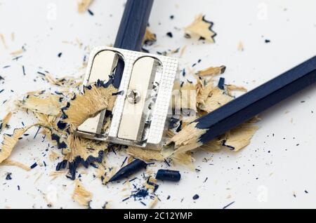 Blue broken pencil in the sharpening and shavings around Stock Photo