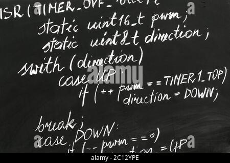 A detail of computer code in AVR explained with white chalk Stock Photo