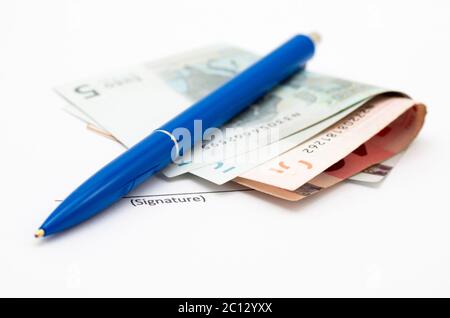 Signature field and pen with money isolated on white background Stock Photo