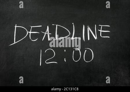 Deadline and time writed on blackboard with chalk Stock Photo