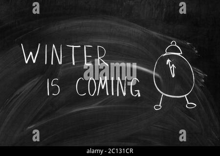 winter is coming handwritten on a chalkboard with chalk Stock Photo