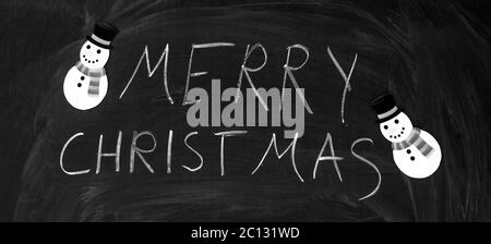 Merry christmas written on the blackboard with chalk Stock Photo