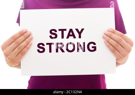 Girl holding white paper sheet with text Stay strong Stock Photo