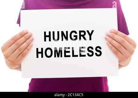 Girl holding white paper sheet with text Hungry homeless Stock Photo