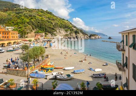 Sandy beach and clear blue water on the old side of the village of Monterosso Al Mare on the Ligurian coast of Cinque Terre, Italy. Stock Photo