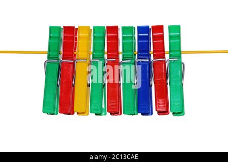 isolated colored plastic clothespins hanging on the rope. Stock Photo