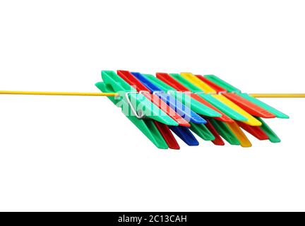 isolated colored plastic clothespins hanging on the rope. Stock Photo