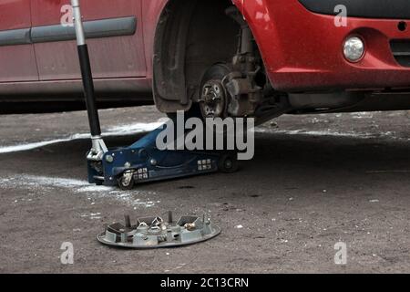 installation of passenger car wheel and replacement on winter tire. Stock Photo