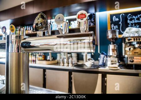 La defense, France - July 17, 2016: Draught beer taps in a big traditional french restaurant in la defense city, the greatest bu Stock Photo