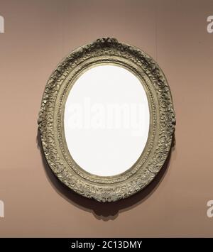 Old-fashioned oval frame on wall Stock Photo