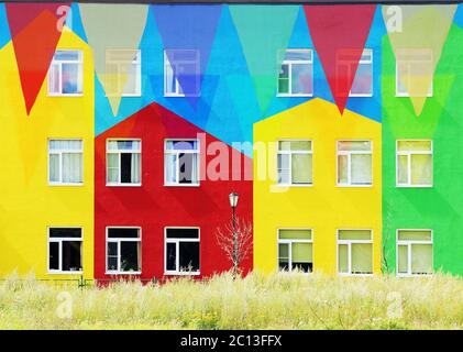 Multi Colored Triangular Flags Hanging against the backdrop of colorful houses. Stock Photo
