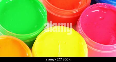 Children's colorful finger paints in jars Stock Photo