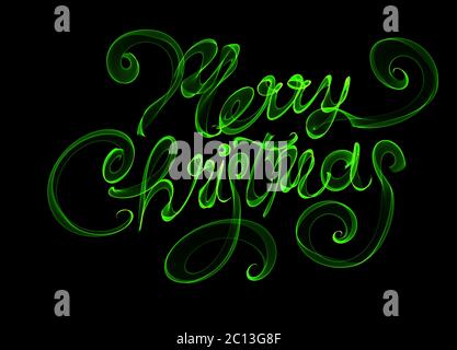 Merry Christmas isolated text written with flame fire light on black background. Green color Stock Photo