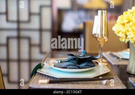 elegant crockery on dining table in modern dining room Stock Photo