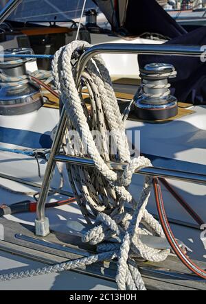 Closeup details of Marine ropes, railing and winches on a Yacht deck. Stock Photo