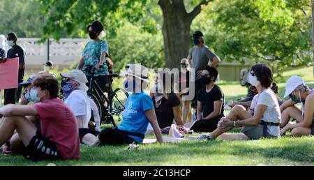 Protestors Wearing Face Masks Of U.s. President Barack Obama And 