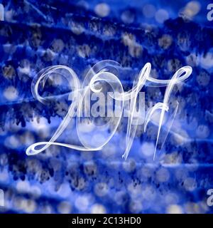 2017 lettering numbers written with fire flame or smoke on blurred light bokeh background Stock Photo