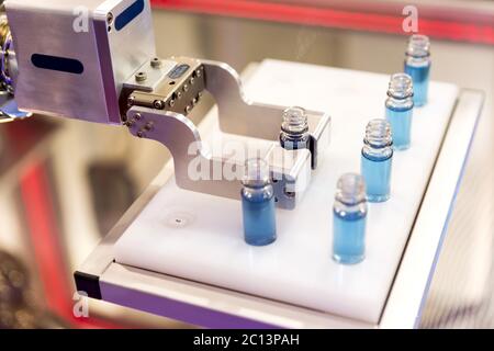 Robot mechanical arm with chemical tubes in a medical laboratory Stock Photo