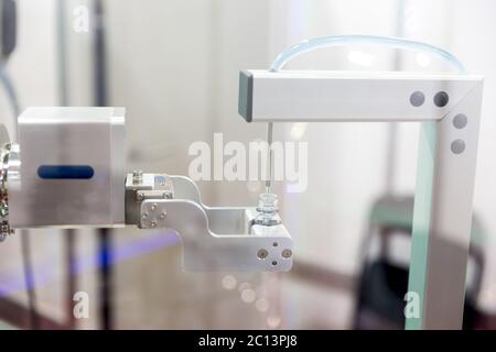 Robot mechanical arm with chemical tubes in a medical laboratory Stock Photo