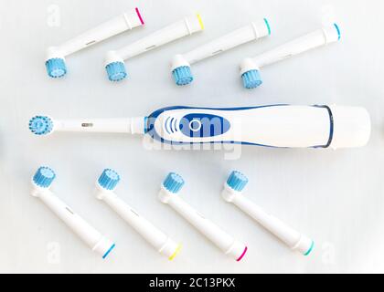 Electronic toothbrush with toothbrush heads on white Stock Photo