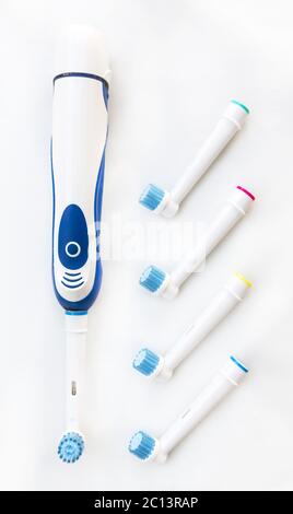 Electronic toothbrush with toothbrush heads on white Stock Photo
