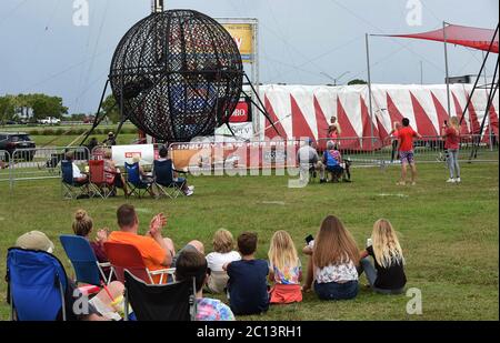 June 13, 2020 - Sarasota, Florida, United States - Spectators watch as motorcyclists perform in a steel globe at Nik Wallenda's Daredevil Rally, billed as the world's first drive-in stunt show, on June 13, 2020 in Sarasota, Florida. The show, which runs on select dates through June 21, features internationally known daredevil performers and is designed to be a safe event during the coronavirus pandemic, with the separation of spectator's vehicles according to social distancing guidelines. (Paul Hennessy/Alamy) Stock Photo