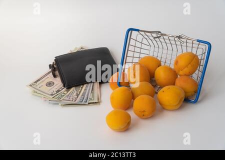 food cart with apricots and money. selective focus. the concept of increasing the price of fruit Stock Photo