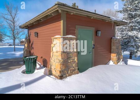 Wooden shed at the snow covered yard of a neighborhood in Wasatch Mountains Stock Photo
