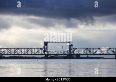 white cumulus clouds pass bridge over the Northern Dvina River. Stock Photo