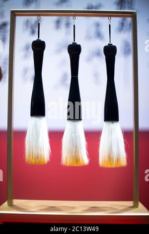 hanging calligraphy brushes on steel frame Stock Photo