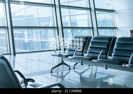 empty airport terminal waiting area with chairs Stock Photo