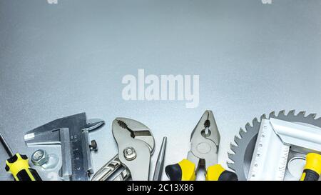 various hand tools. many working tools on a grey metal background Stock Photo