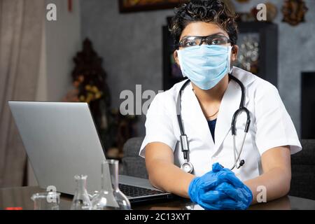 Medical concept of young beautiful female doctor wearing mask and in white coat with stethoscope. Woman hospital worker looking at camera Stock Photo
