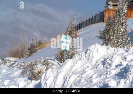 Building and Church Parking Only sign on the snowed in slope of Wasatch Mountain Stock Photo