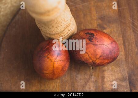 Easter eggs on wooden background. Painted brown with spots and cracks Stock Photo