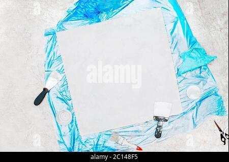 plastered Board, metal spatula, jar of cement, brush for molar paint, blue rag and a blue celophane floor covering. self-repair and home decor, buildi Stock Photo
