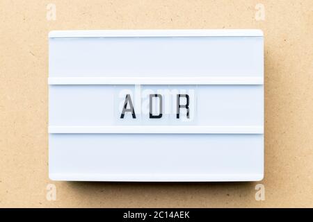 White lightbox with word ADR (Abbreviation of Adverse drug reaction) on wood background Stock Photo