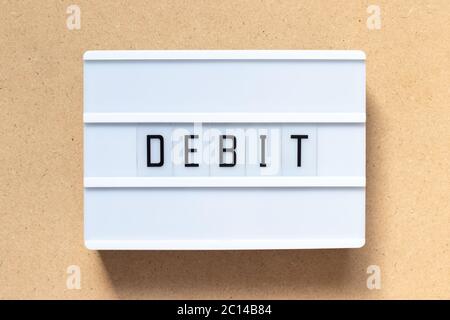 White lightbox with word debit on wood background Stock Photo