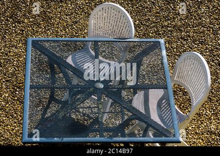 Overhead view of garden table and chairs in courtyard. Stock Photo