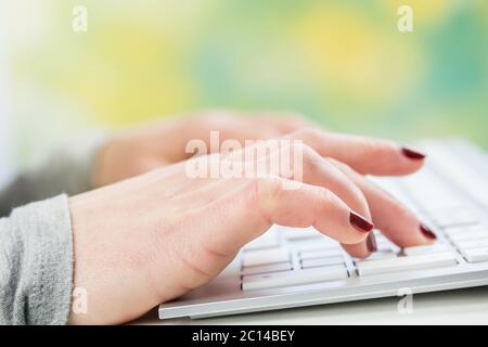 Female hands or woman office worker typing on the keyboard Stock Photo