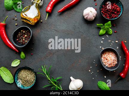 Frame of spices, herbs and vegetables on a dark stone background. Top view, flat lay. Stock Photo