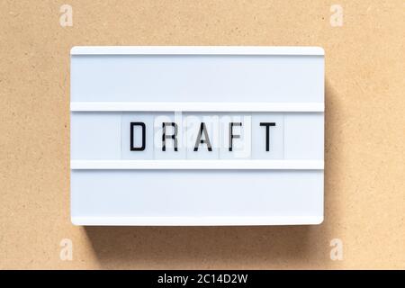 White lightbox with word draft on wood background Stock Photo