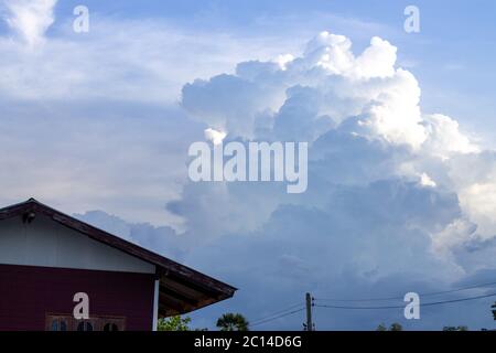 Dark and violent storm clouds in the background Before rain in the rainy season Stock Photo