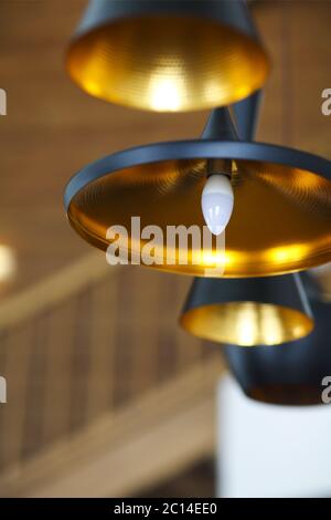 Black pendant lamp on ceiling wood wall Stock Photo