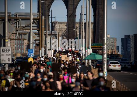 New York, USA. 13th June, 2020. Demonstrators take part in a protest sparked by the death of George Floyd across the Brooklyn Bridge in New York, the United States, June 13, 2020. Credit: Michael Nagle/Xinhua/Alamy Live News Stock Photo